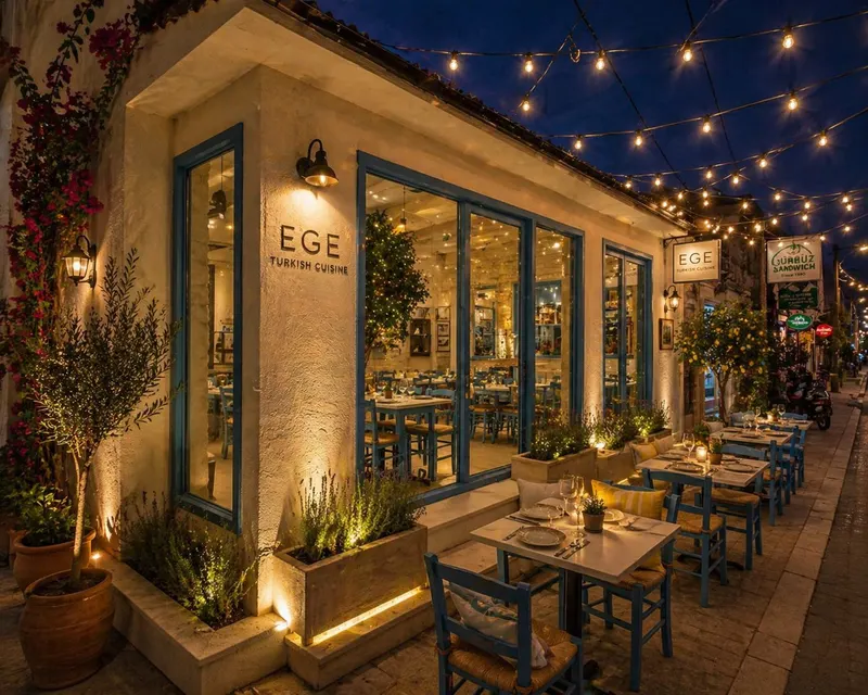 The taverna at night: string lights over blue chairs and set street-side tables